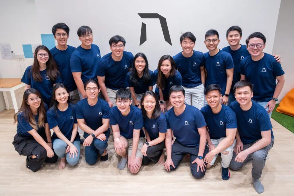 The Team Behind Singapore’s Leading AI Courses — Heicoders Academy Group photo of Heicoders Academy team members in matching navy shirts, representing the community and educators behind AI courses in Singapore.