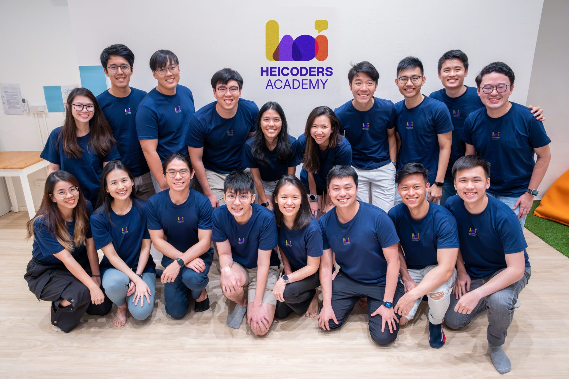 The Team Behind Singapore’s Leading AI Courses — Heicoders Academy Group photo of Heicoders Academy team members in matching navy shirts, representing the community and educators behind AI courses in Singapore.
