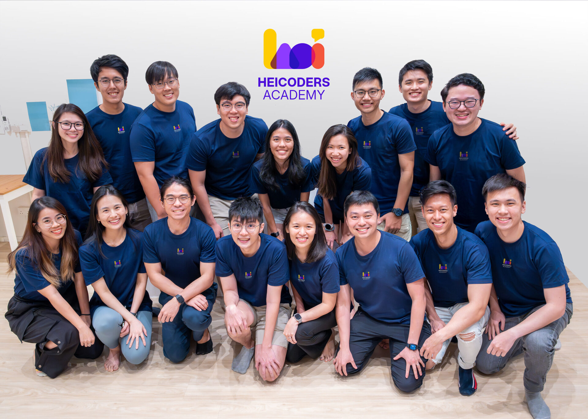 new-group-pic Group photo of Heicoders Academy team members in matching navy shirts, representing the community and educators behind AI courses in Singapore.