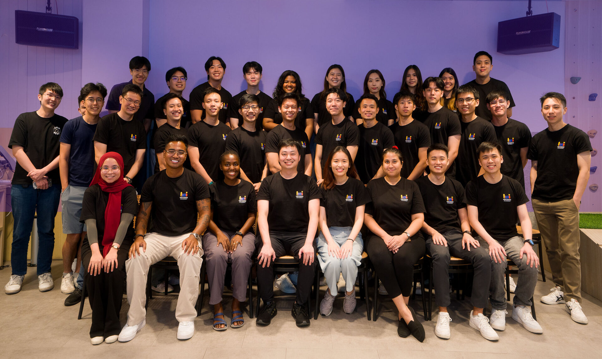 Group photo of Heicoders Academy team members in matching navy shirts, representing the community and educators behind AI courses in Singapore.